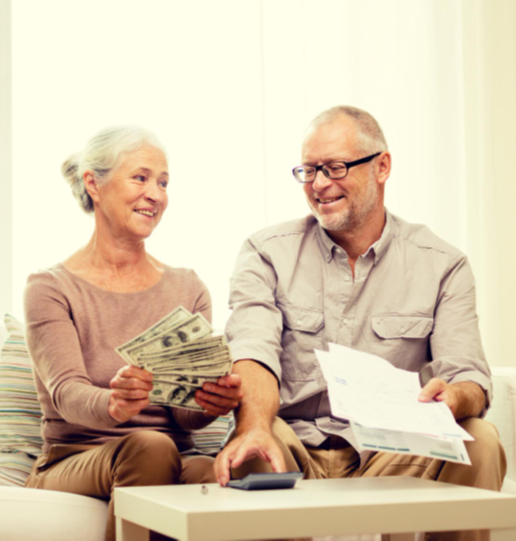 Retired couple happily reviewing finances