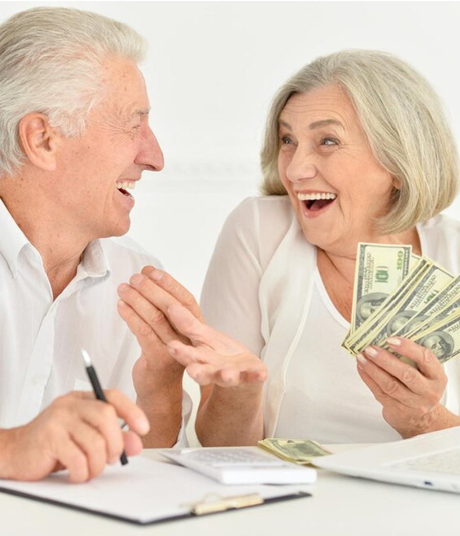Retired couple laughing with cash
